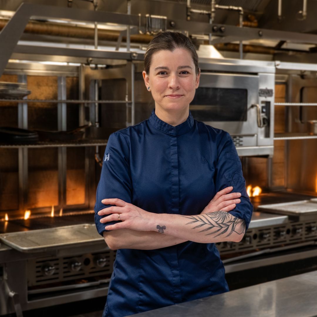 A table with a layered dessert, roasted meat, and various dishes, including a salad.